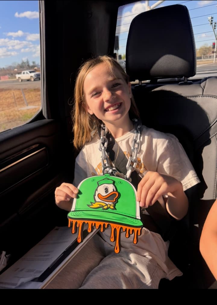 Young athlete displaying a custom green and orange duck-logo hype chain