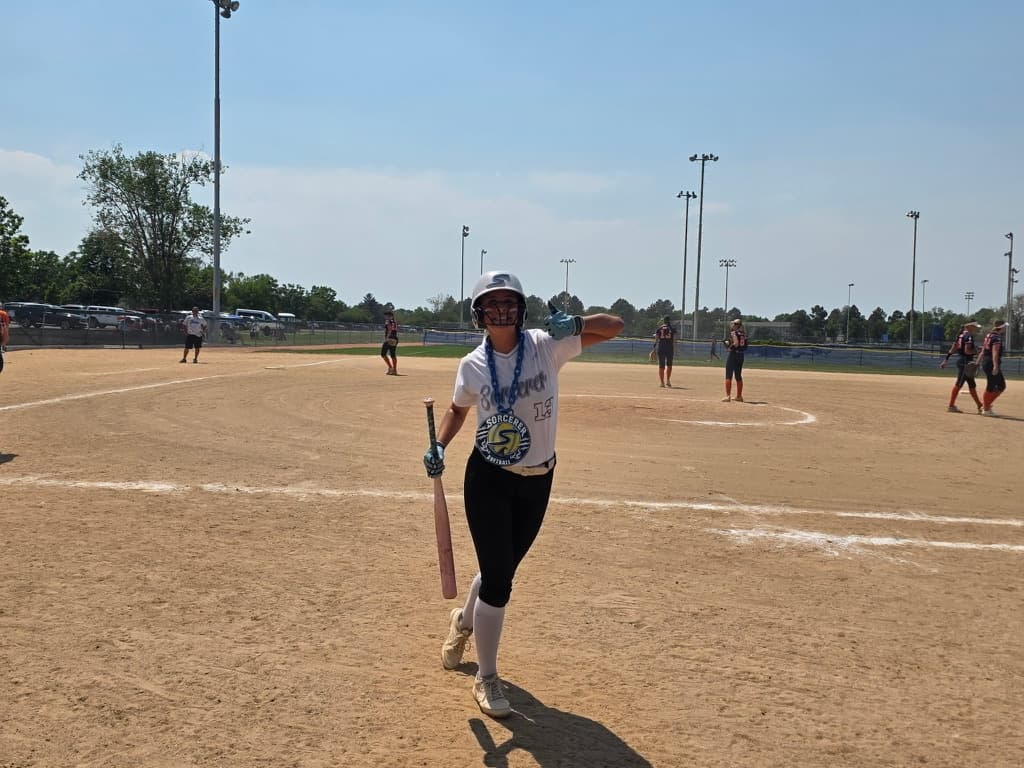 Sorcerer softball player wearing a custom team chain on the field